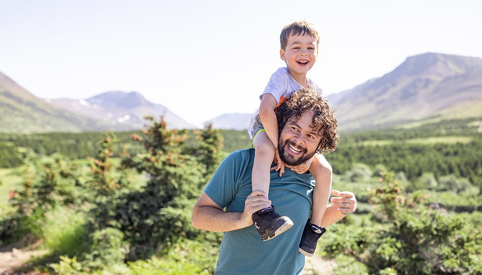 Dad Giving Son Piggyback Ride While Hiking